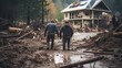 Two individuals walking hand in hand amidst the devastation of a muddy flood, with a damaged house in the background