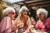Fototapeta  - diverse senior women drinking wine or champagne at restaurant or hotel bar. Retired lady friends smiling, being happy and enjoying life. 