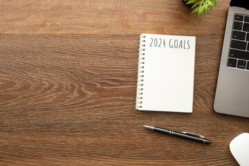 Wall Mural - Notebook with 2024 goals text on it to apply new year resolutions and plan.