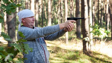 A Middle Aged Man Learns To Aim From A Co2 Air Pistol.