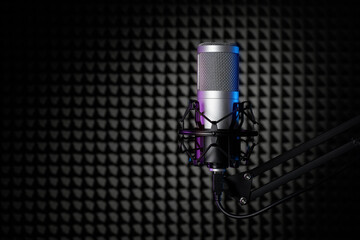 Wall Mural - Professional condenser microphone in the sound recording studio with soundproof wall panel.