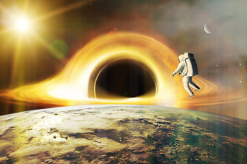 Wall Mural - realistic science fiction art. spaceman looks at black hole on low-orbit of earth planet. elements o