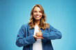 © Maria Vitkovska - Portrait of smiling attractive confident deaf sign language interpreter or  teacher communicating by hands gestures isolated on blue background. Nonverbal communication concept