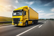 A yellow truck on the road. Blurred background. Generative AI.