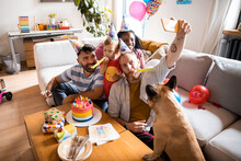 Male Gay Couple With Children Celebrating Birthday At Home