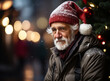 Portrait of wrinkled sad elderly man in red santa claus hat sitting and looking at camera. Lonely old bearded man on Christmas Eve alone on street. Concept of lonesome, sadness, melancholy and dismals