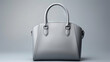 Beautiful trendy smooth youth women's handbag on a gray studio background.