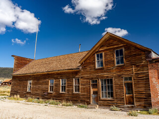 Weathered old abandoned building on a summer day