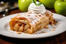 piece of classic apple strudel with white cream or ice cream and meant. Austrian cuisine. apple