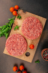 Poster - Raw Ground beef meat Burger steak cutlets on a wooden board, Food recipe background. Close up