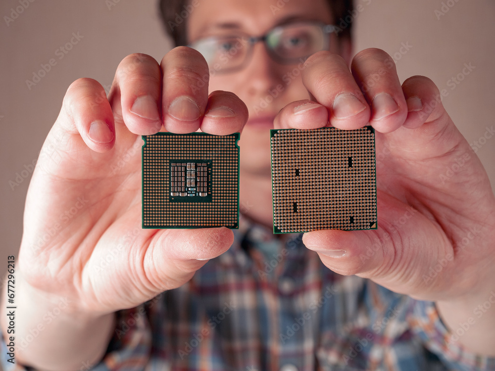 Hand holding cpu modules to assemble a computer, choosing the right components for a computer, types of central processor unit isolated