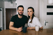 © BullRun - Positive couple resting in modern kitchen