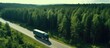 Bird s eye view of gasoline truck on highway road near green forest Copy space image Place for adding text or design
