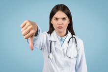 Stern Female Doctor Giving Thumbs Down Gesture