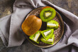 Close up of fresh ripe sliced kiwi fruit on a plate on the table top view