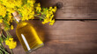 top view Still life with rapeseed oil in bottles and rape flowers as decortation on a wooden table with text space