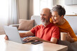 © Prostock-studio - Tech-Savvy Seniors. Happy Older Couple Using Laptop Together At Home