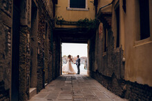 Beautiful bride and groom dancing at the old Venice city with wonderful architecture. Wedding day in Italy