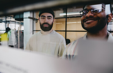 Canvas Print - Smiling bearded young men working in office