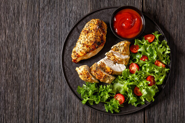 Wall Mural - Baked Split Chicken Breasts with salad on plate