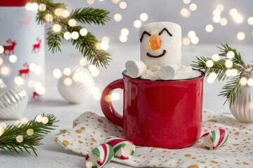 Wall Mural - Red mug with hot chocolate with melted marshmallow snowman