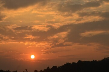 Canvas Print - Beautiful shot of the sunset behind the clouds in the evening