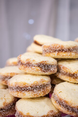 Stack of cornstarch Alfajores with coconut around