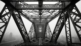 Fototapeta  - Artistic black-and-white photo capturing the underside of metal scaffolding on a large structure, evoking a sense of industrial complexity and architectural beauty.