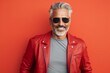 Portrait of a handsome mature man in red leather jacket and sunglasses