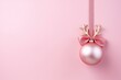Pink Christmas ball with reindeer antlers on pastel rose background. Minimal New year concept with copy space. Xmas design for banner and greeting card