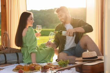 Wall Mural - Romantic date. Beautiful couple having picnic outdoors on sunny day