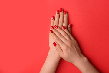 Wall Mural - Woman with gel polish on nails against red background, closeup. Space for text