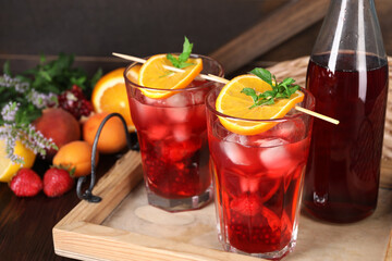 Canvas Print - Glasses and bottle of delicious refreshing sangria on table