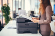 Office worker print paper on multifunction laser printer. Document and paperwork. Secretary work. Woman working in business office. Copy, print, scan, and fax machine. Print technology.