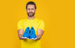 © be free - fitness man with sneakers isolated on yellow, copy space. fitness man with sneakers