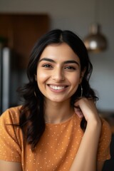 Wall Mural - Smiling beautiful young woman sitting at her home kitchen looking at the camera