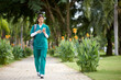 © DragonImages - Medical nurse checking notifications on smartphone when walking to workplace