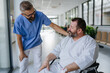 © Halfpoint - Close up of supportive doctor talking with worried overweight patient in wheelchair. Illnesses and diseases in middle-aged men's health. Compassionate physician supporting stressed patient. Concept of