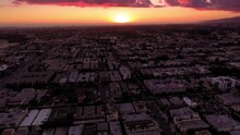 Aerial Forward Tilt Up Beautiful View Of Buildings In City Against Cloudy Sky During Sunset - Culver City, California