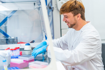 Wall Mural - young scientist working on cells in a cancer research laboratory