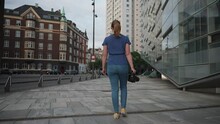 A Woman Walking Down A Street