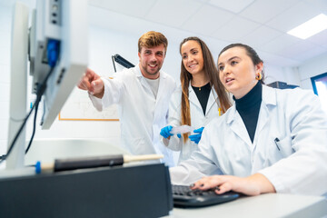 Wall Mural - happy doctors using computer in a research laboratory
