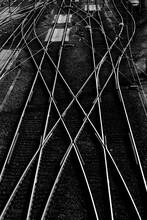 Railway Tracks And Switches At A Big Station Forming Geometrical And Symmetrical Structures And Lines. Main Station In Hagen Westphalia Germany. Black And White With High Contrast, View From A Bridge.