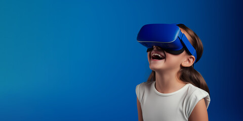 young girl getting experience using vr headset glasses isolated on a blue background with copy space