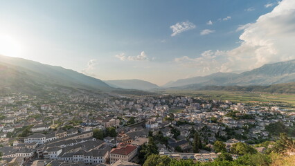 Wall Mural - Panorama showing sunset over Gjirokastra city from the viewpoint of the fortress of the Ottoman castle of Gjirokaster timelapse.