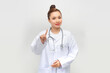 Strict doctor girl raised forefinger stop sign wear stethoscope white uniform on white background