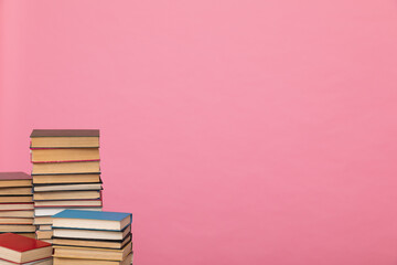 stack of books on a pink background in the learning library