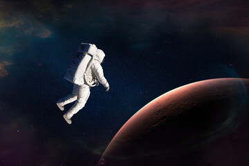 Wall Mural - astronaut in outer space close to mars planet. elements of this image furnished by nasa.