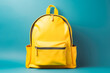 © VisualProduction - School backpack with books on blue background with space for text. Going to school concept photo.