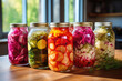 Fermented vegetables in jars on kitchen table
